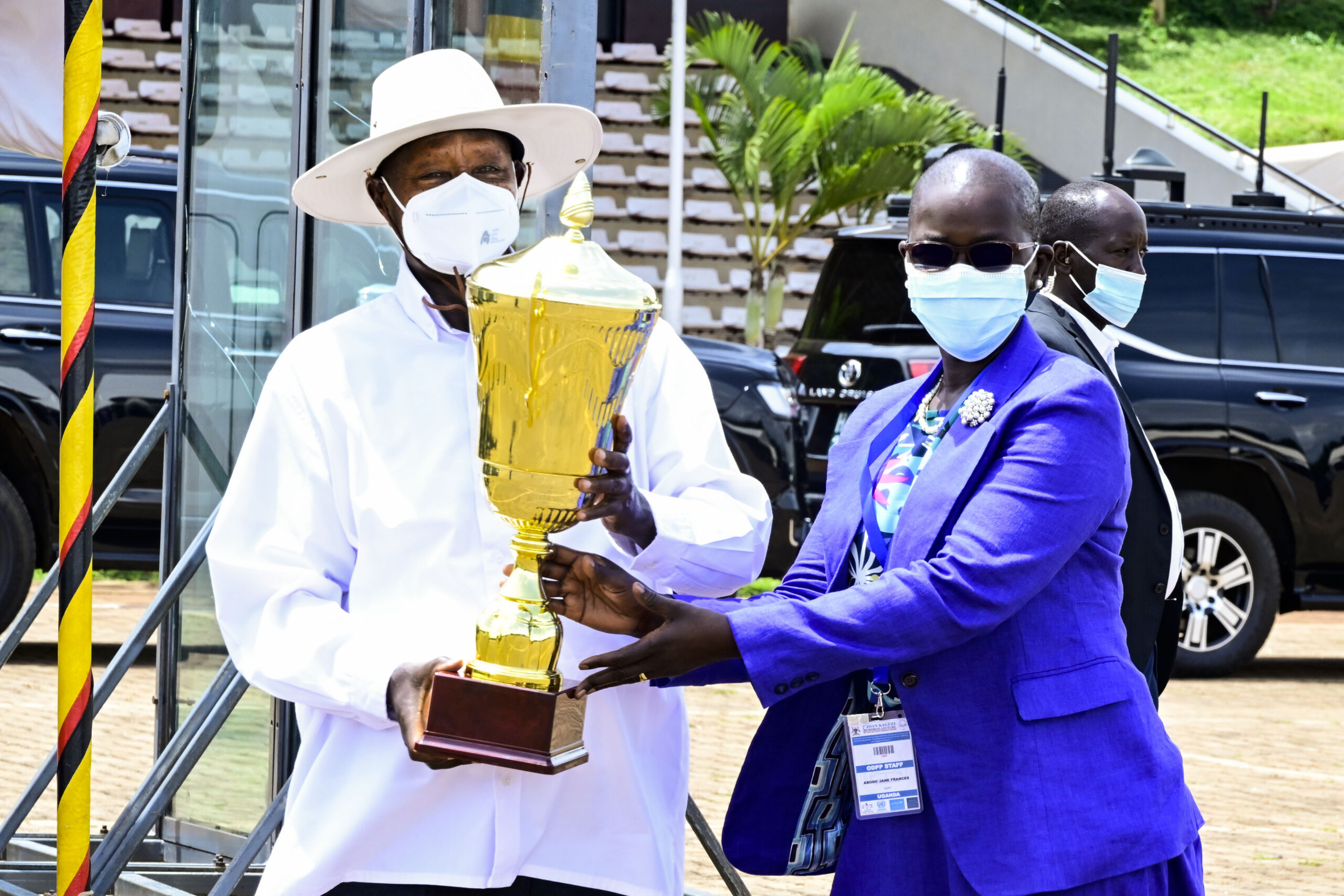 DPP Jane Adobo presents a trophy to President Museveni as an award during the 7th Joan Kagezi memorial lecture at Kololo on. Thursday April 25. PPU Photo scaled oOMCy0 MooChat Plus